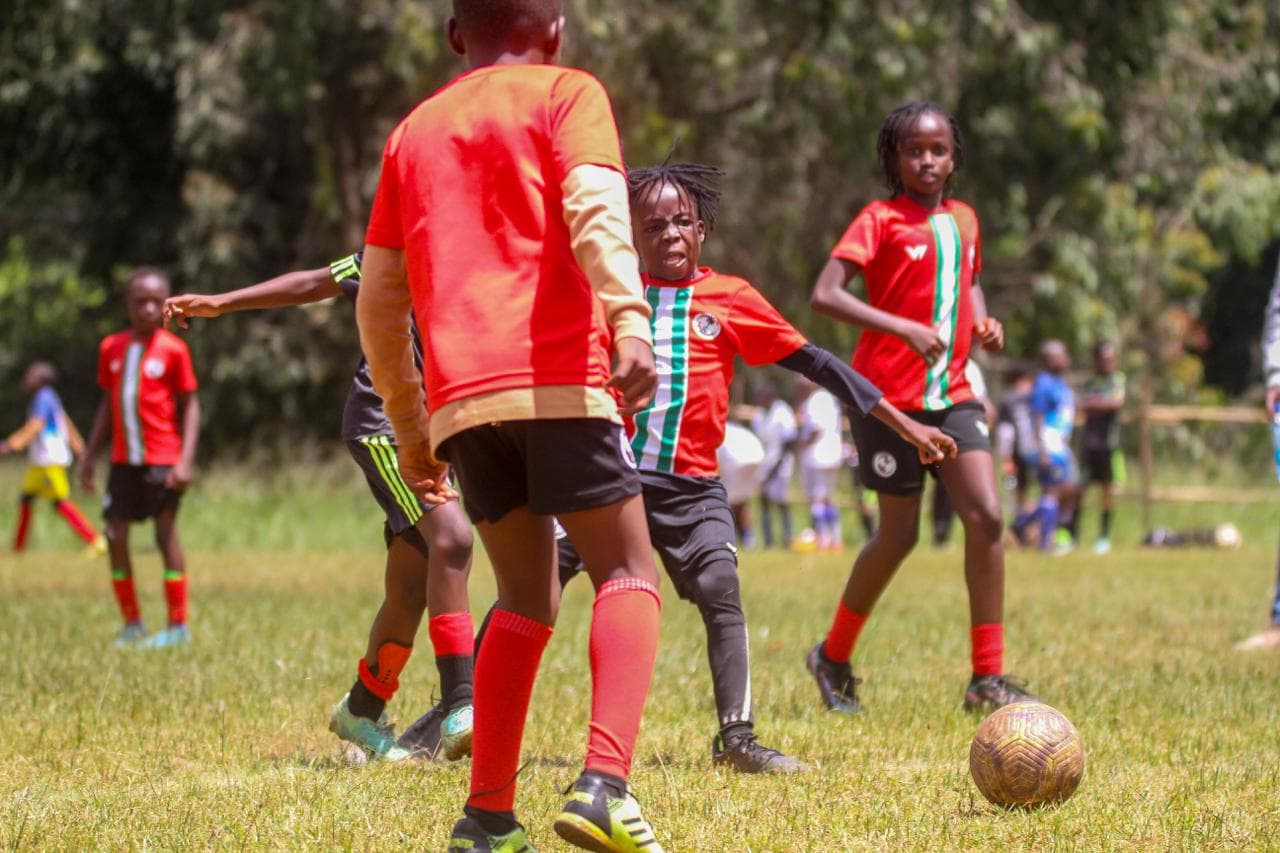 Young footballers celebrating teamwork and success together